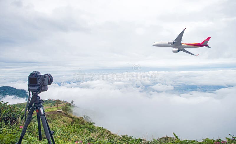 DSLR camera taking travel nature photography. full frame camera on tripod take photograph of airplane take off with beautiful landscape in background. DSLR Camera shooting an airplane. DSLR camera taking travel nature photography. full frame camera on tripod take photograph of airplane take off with beautiful landscape in background. DSLR Camera shooting an airplane